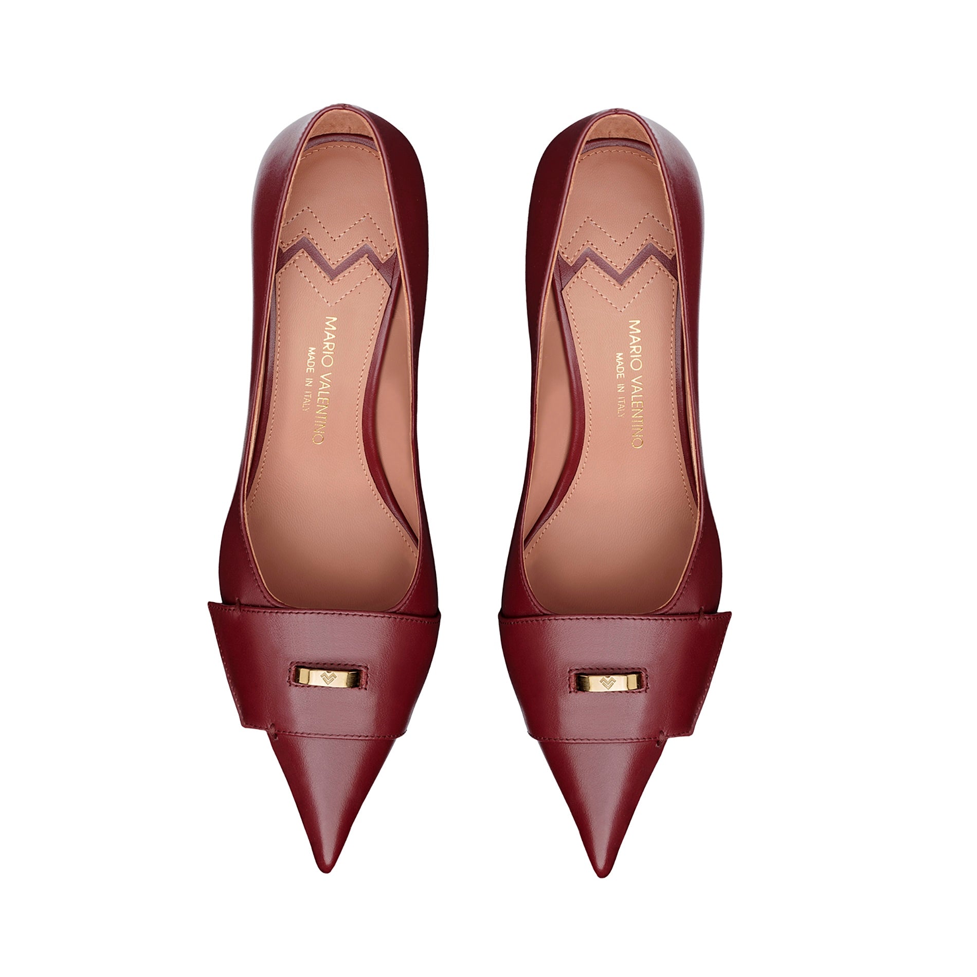 Top view of burgundy pointed toe leather pumps with gold logo detail and refined design