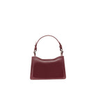 Back view of a structured burgundy leather mini bag with curved silhouette and adjustable leather handle.