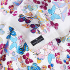 Close-up of Mario Valentino silk scarf fabric showing butterfly motif detail and refined Italian craftsmanship.