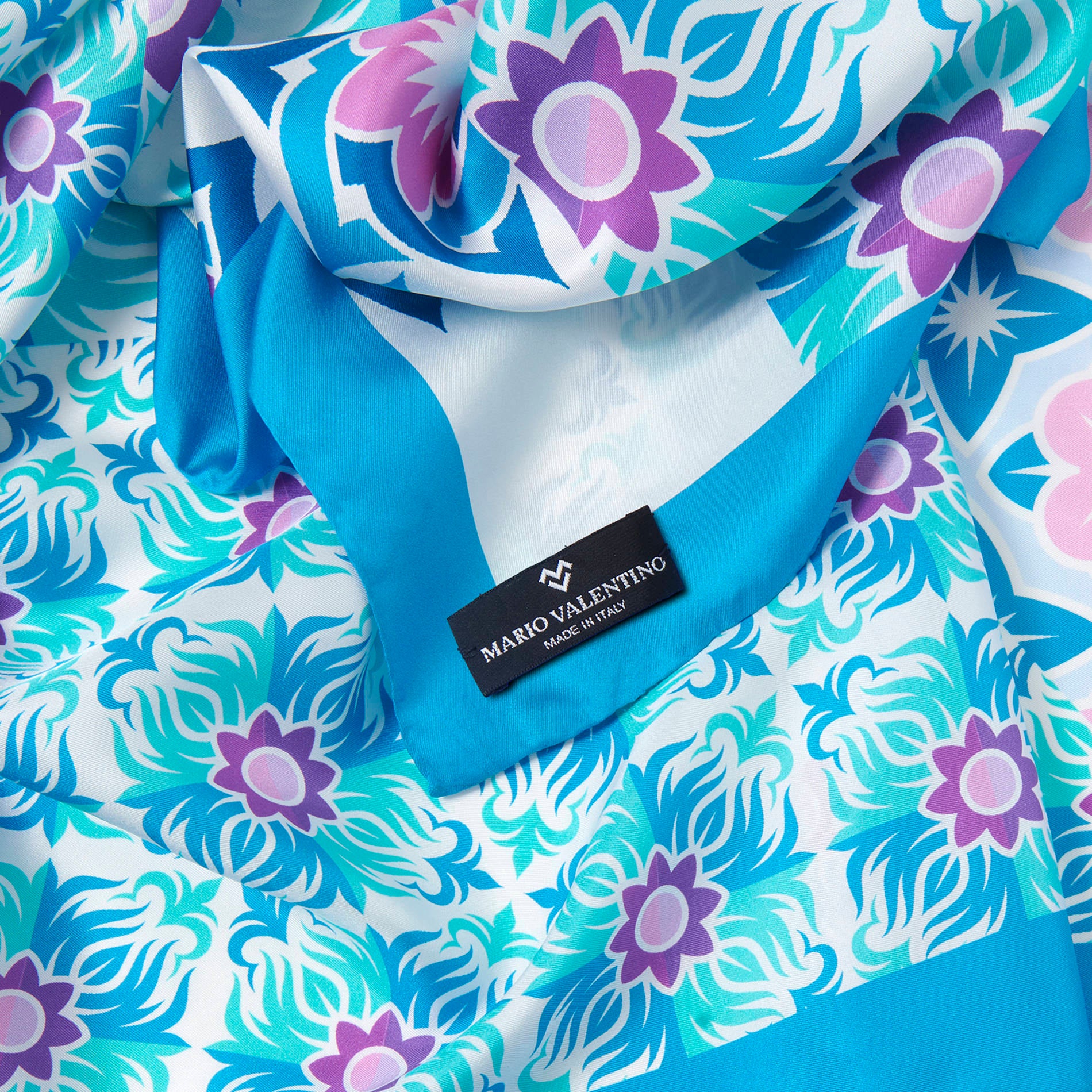 Detail of floral abstract print silk scarf by Mario Valentino, pure silk texture with soft and fluid finish