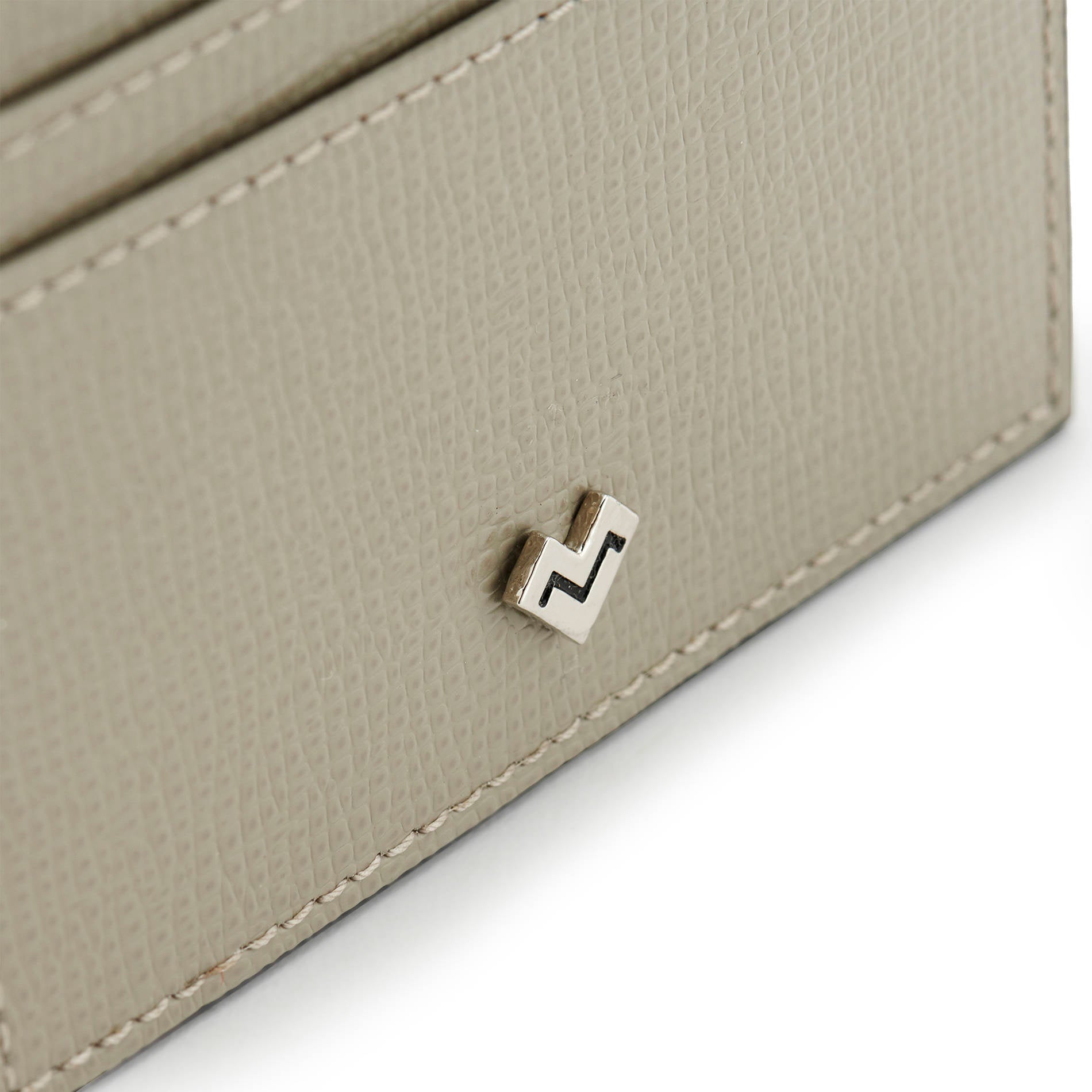 Detail of grey grained leather card holder with metal MV logo