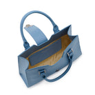 Interior view of the Mario Valentino blue handbag showing the logoed lining and internal storage