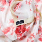 Mario Valentino black logoed label on a pure silk floral foulard, Made in Italy designer accessory detail.