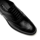 lose-up of black calfskin brogue Oxford shoes showing wingtip perforations and fine leather texture