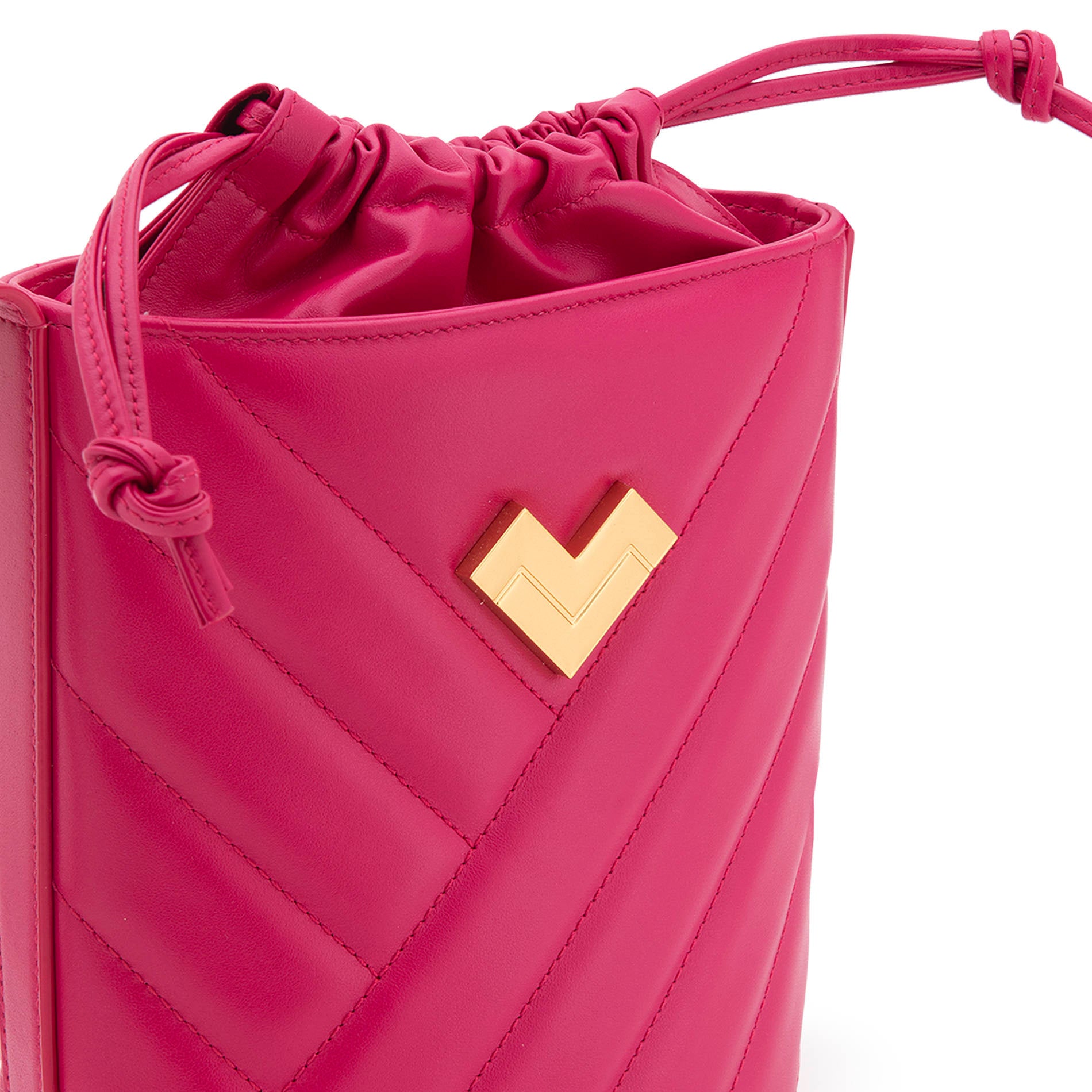 Bright pink quilted leather crossbody bucket bag in a rich magenta shade with gold-tone logo and chevron stitching detail. Made in Italy