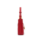 Profile view of red leather shoulder bag by Mario Valentino with adjustable strap and gold logo closure, compact everyday style
