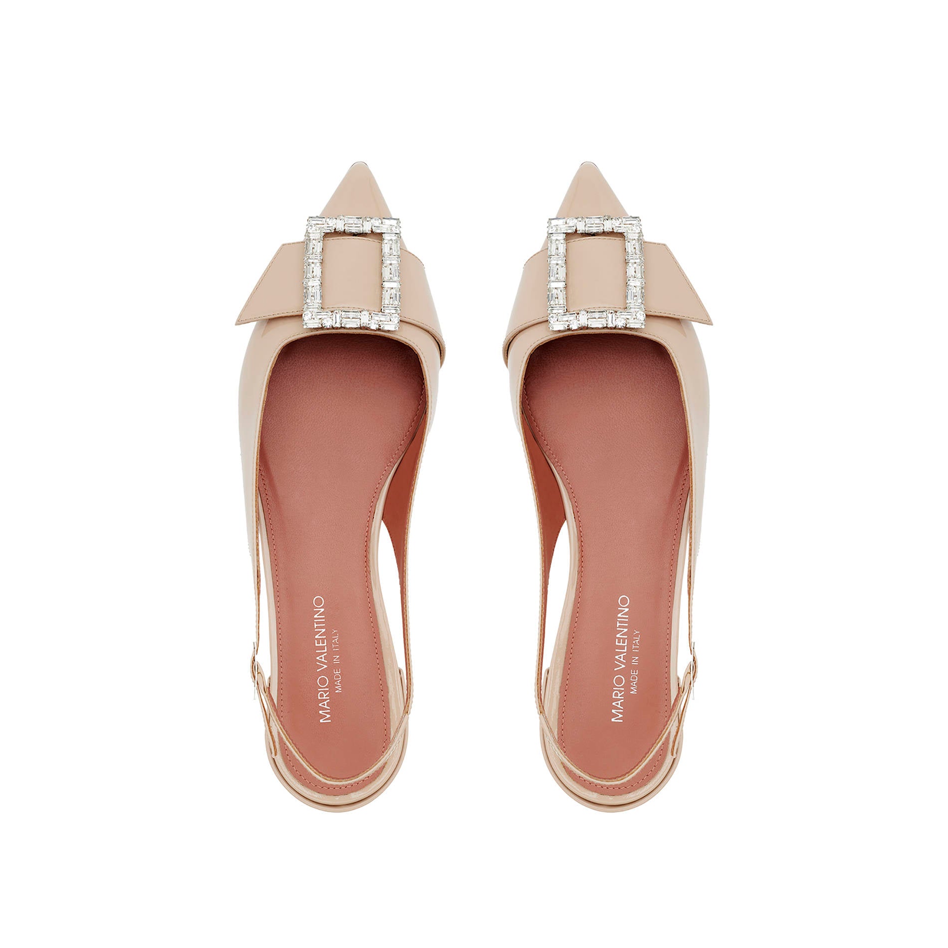 Top view of nude patent leather pointed toe slingback flats with buckle detail